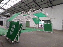White design structure Fastival with green panels and logos for brand activation